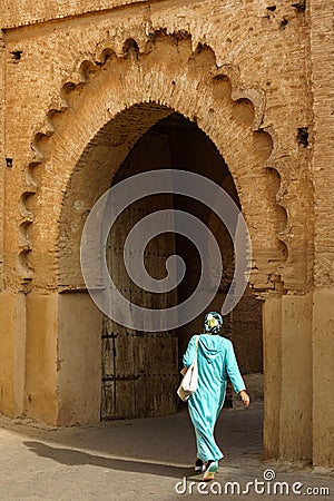 Morocco. Taroudant. A woman in a chador in front of the Bab Sedra gate of the city walls Editorial Stock Photo