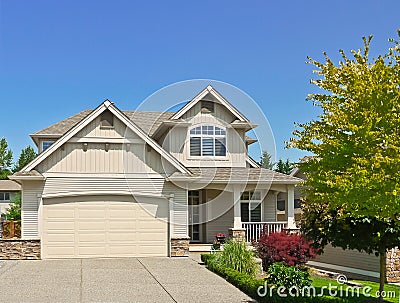 North american family house with concrete driveway to the garage on blue sky background Stock Photo