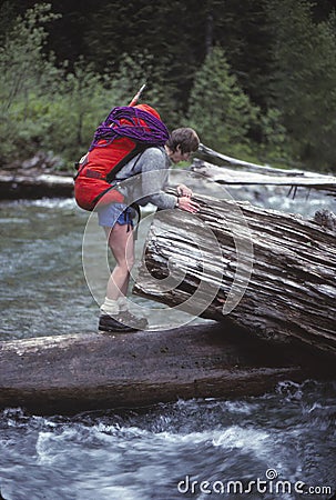 Climber crossing the Sauk River on a log Editorial Stock Photo
