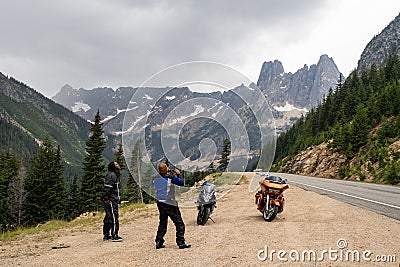 North Cascades, Washington - July 5, 2019: Two African American men friends riding motorcycles take photos of Liberty Bell Editorial Stock Photo