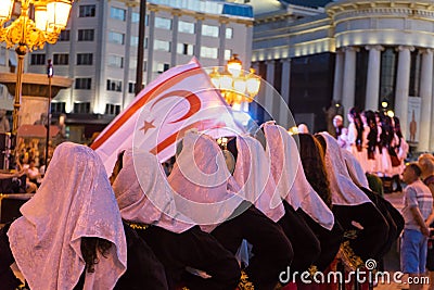 North Cyprus traditional costume and Big flag in a festival at Skopje. Folklore Street celebration in balkans countries with folk Editorial Stock Photo