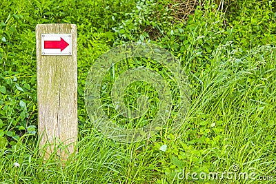 North German red arrow directional sign meadow forest nature Germany Stock Photo