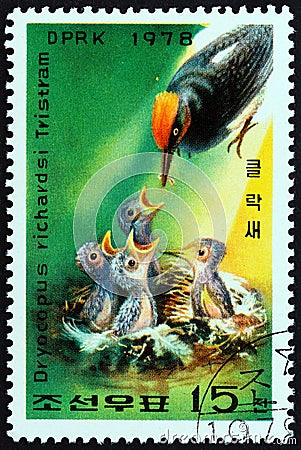 NORTH KOREA - CIRCA 1978: A stamp printed in North Korea shows Woodpecker feeding young, circa 1978. Editorial Stock Photo