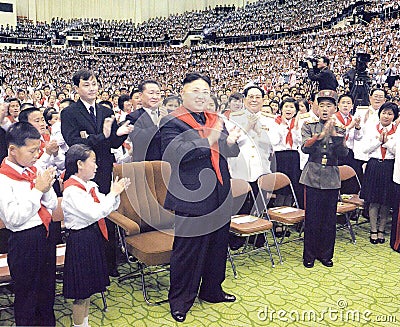 North Korean Supreme Leader Kim Jong-un between comrades and young pioneers Editorial Stock Photo
