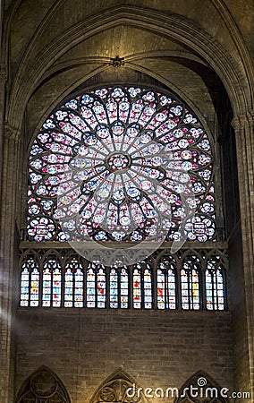 North rose stained glass window with a row of figures below inside of Notre-Dame de Paris cathedral, Paris Editorial Stock Photo