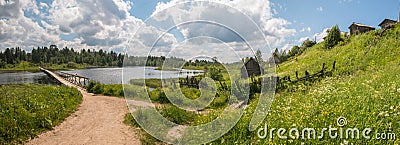 North Russian village. Summer day, river, old cottages on coast. Stock Photo