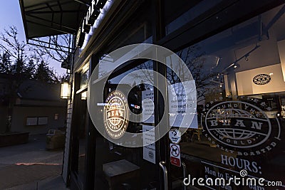 NORTH VANCOUVER, BC, CANADA - MAR 19, 2020: A health notice sign in the front of a store mandating social distancing Editorial Stock Photo