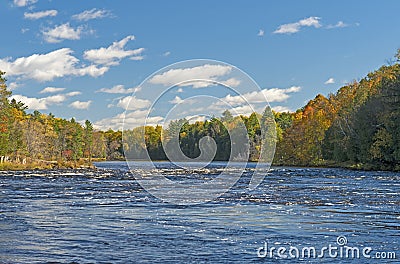 North Woods River Flowing into the Fall Colors Stock Photo