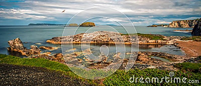 Northern Ireland Antrim Coast Ballintoy Harbour long exposure rocks sunset waves beautiful scenery Stock Photo