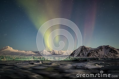 Northern Lights above the Arctic glacier and mountains - Svalbard, Spitsbergen Stock Photo