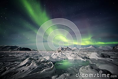 Northern Lights above the Arctic glacier and mountains - Svalbard, Spitsbergen Stock Photo