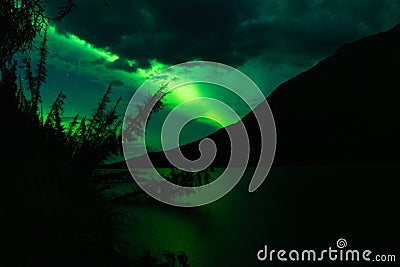 Northern Lights above lake with reflection of Aurora Stock Photo