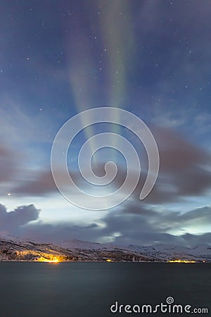 Northern lights Aurora borealis at the lakeside with rocks of a Stock Photo