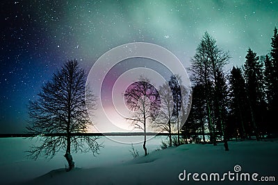 Northern lights Aurora Borealis activity over the lake in winter Finland Stock Photo