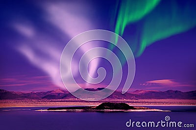 Northern lights aurora borealis in the night sky over beautiful lake landscape Stock Photo