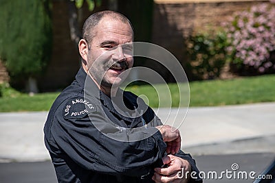 LAPD dectective Fillmore from LAPD`s metro division smiles after Valley Homicide Detectives serve a warrant Editorial Stock Photo