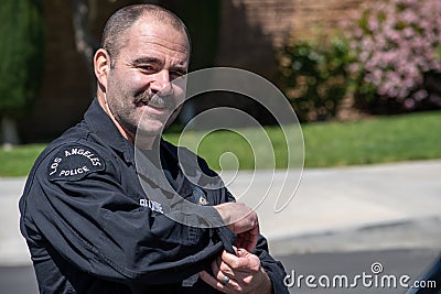 LAPD dectective Fillmore from LAPD`s metro division smiles after Valley Homicide Detectives serve a warrant Editorial Stock Photo