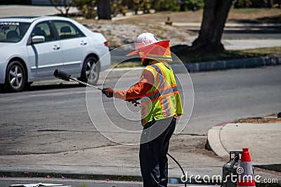 Northridge, California, United States - June 28, 2022: A contractor from Paveco Construction working for the City of Los Angeles Editorial Stock Photo