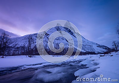 Norway. Frozen river and mountain. A classic view in Norway during winter. Cold weather and a snow storm. Stock Photo