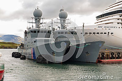 Coast Guard vessels and MSC Magnifica cruise ship in Reykjavik harbour Editorial Stock Photo