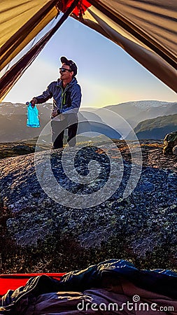 Norway - A man bringing the water to the tent Stock Photo