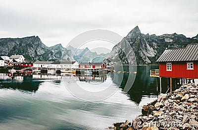 Norway rorbu houses and mountains rocks over fjord Stock Photo