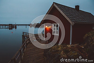 Norway rorbu houses and mountains rocks over fjord landscape scandinavian travel view Lofoten islands. Night landscape Stock Photo