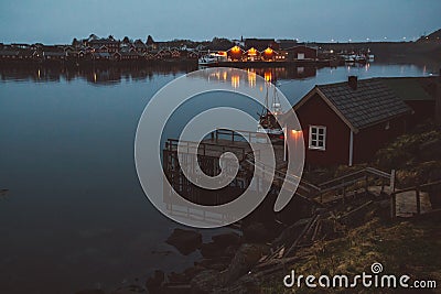 Norway rorbu houses and mountains rocks over fjord landscape scandinavian travel view Lofoten islands. Night landscape. Stock Photo