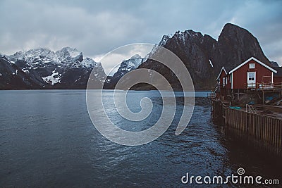 Norway rorbu houses and mountains rocks over fjord landscape scandinavian travel view Lofoten islands. Night landscape Stock Photo