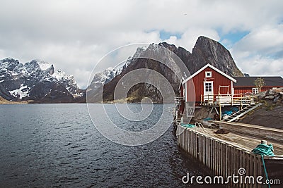 Norway rorbu houses and mountains rocks over fjord landscape scandinavian travel view Lofoten islands. Natural scandinavian Stock Photo