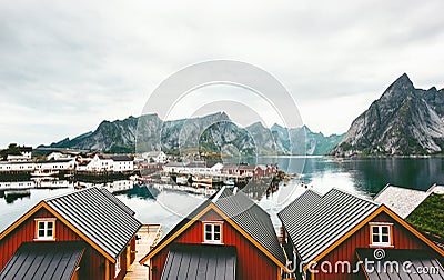 Norway village traditional houses roofs and mountain rocks over fjord Stock Photo