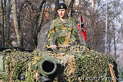 Norwegian Army armored tank with cannon and camouflage coating with soldier Editorial Stock Photo