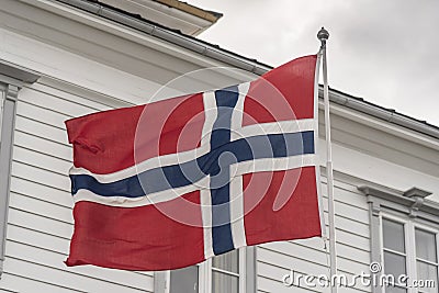 Norwegian flag on the summit of FlÃ¸yen Mountain Bergen. Stock Photo