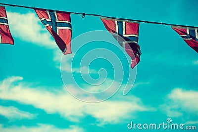 Norwegian flags against blue sky Stock Photo