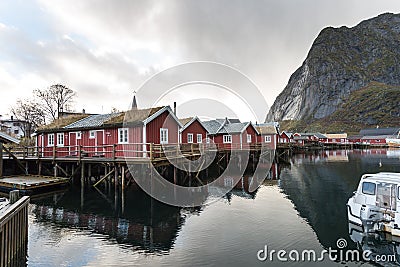 Norwegian old city Reine with reflections in water and cloudy sk Editorial Stock Photo