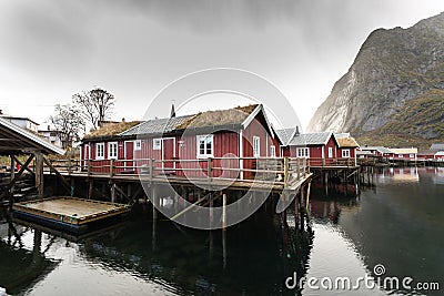 Norwegian old city Reine with reflections in water and cloudy sk Stock Photo