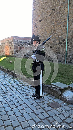 The Norwegian soldier and the old architecture of Oslo. Norway: an old building in a Park next to the Royal Palace in Oslo. Editorial Stock Photo