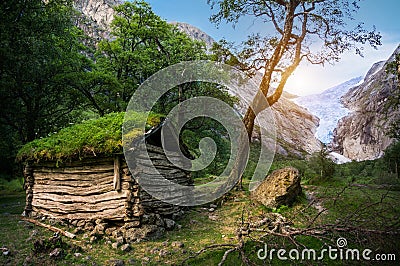 Norwegian typical grass roof wooden old house in glacier panorama Stock Photo