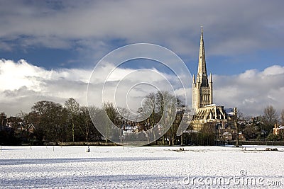 Norwich Cathedral and cricket field in the snow Stock Photo