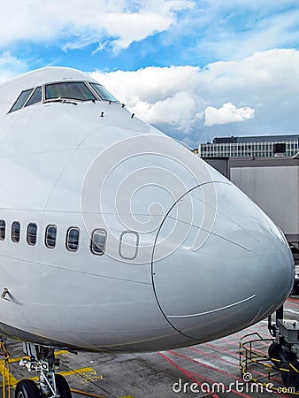 Nose of a large white aircraft at an airport Stock Photo