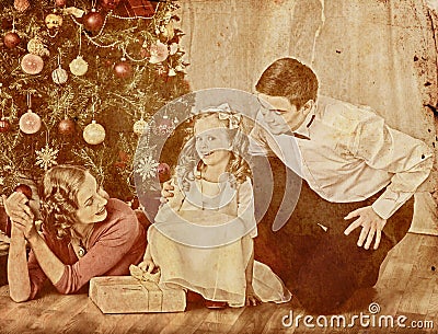 Nostalgy Christmas family with child girl dressing Christmas tree. Stock Photo