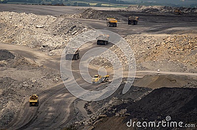 Huge quarry trucks look like toys from above Stock Photo