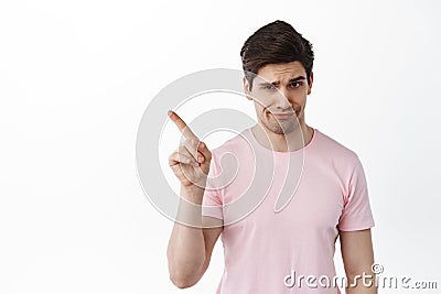 Not so fast. Man shaking finger in rejection, prohibit or forbid something, scolding for bad behavior, smirk and frown Stock Photo