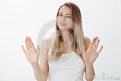 Not really into it. Portrait of woman refusing offer in polite manner smiling friendly wirh sorry look as waving hands Stock Photo