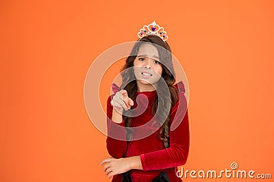 Not you. Kid wear golden crown symbol of princess. Girl cute baby wear crown stand orange background. Childhood concept Stock Photo