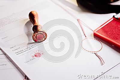 Notary public metal stamper on testament. Stock Photo