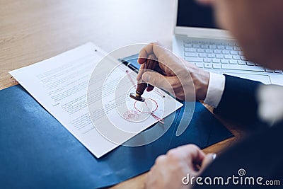 Notary public stamping and notarize document in his office Stock Photo