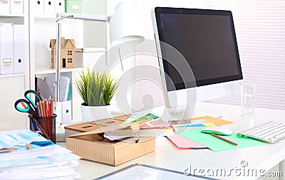 A note book, laptop, pen, graph paper document on the office desk table behind white blind Stock Photo