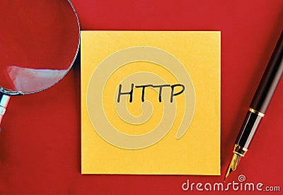 Note featuring HTTP written on a sticky note with a magnifying glass and pen on a red surface Stock Photo