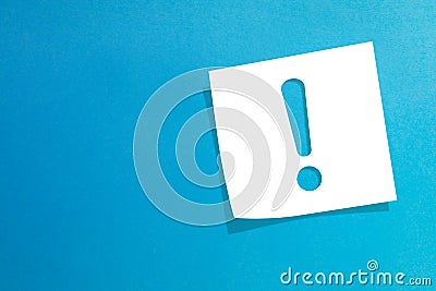 Note paper with exclamation mark on blue background Stock Photo